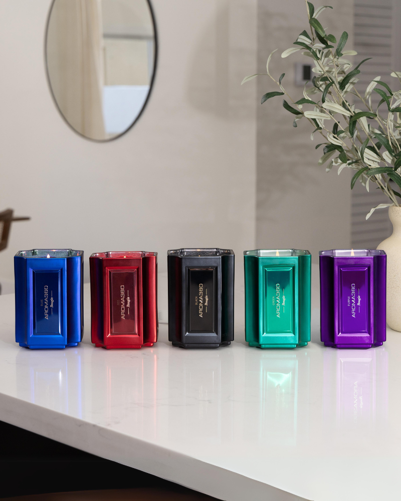 The Bougie Sand Wax Set features a 40oz scented sand wax, 30 candle wicks, and a stunning 33oz recyclable metallic vessel. Available in Blue, Red, Black, Green, and Purple scents, this eco-friendly, refillable candle set offers a sustainable and opulent ambiance.