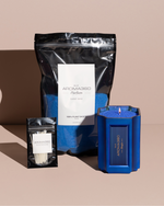 The Bougie Sand Wax Set features a 40oz scented sand wax, 30 candle wicks, and a stunning 33oz recyclable metallic vessel. Available in Blue, Red, Black, Green, and Purple scents, this eco-friendly, refillable candle set offers a sustainable and opulent ambiance.