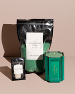 The Bougie Sand Wax Set features a 40oz scented sand wax, 30 candle wicks, and a stunning 33oz recyclable metallic vessel. Available in Blue, Red, Black, Green, and Purple scents, this eco-friendly, refillable candle set offers a sustainable and opulent ambiance.