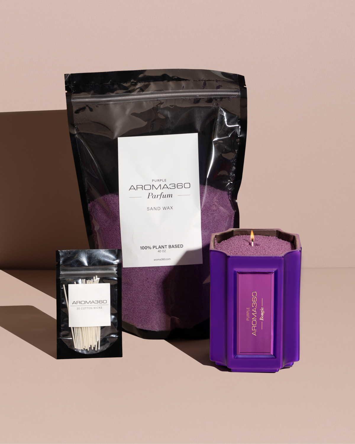 The Bougie Sand Wax Set features a 40oz scented sand wax, 30 candle wicks, and a stunning 33oz recyclable metallic vessel. Available in Blue, Red, Black, Green, and Purple scents, this eco-friendly, refillable candle set offers a sustainable and opulent ambiance.