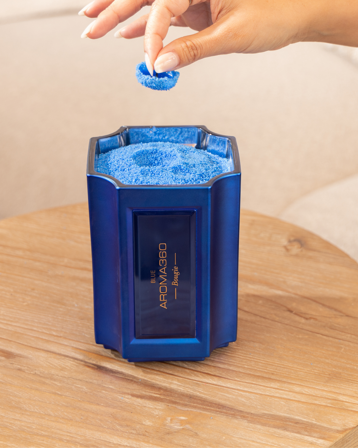 The Bougie Sand Wax Set features a 40oz scented sand wax, 30 candle wicks, and a stunning 33oz recyclable metallic vessel. Available in Blue, Red, Black, Green, and Purple scents, this eco-friendly, refillable candle set offers a sustainable and opulent ambiance.