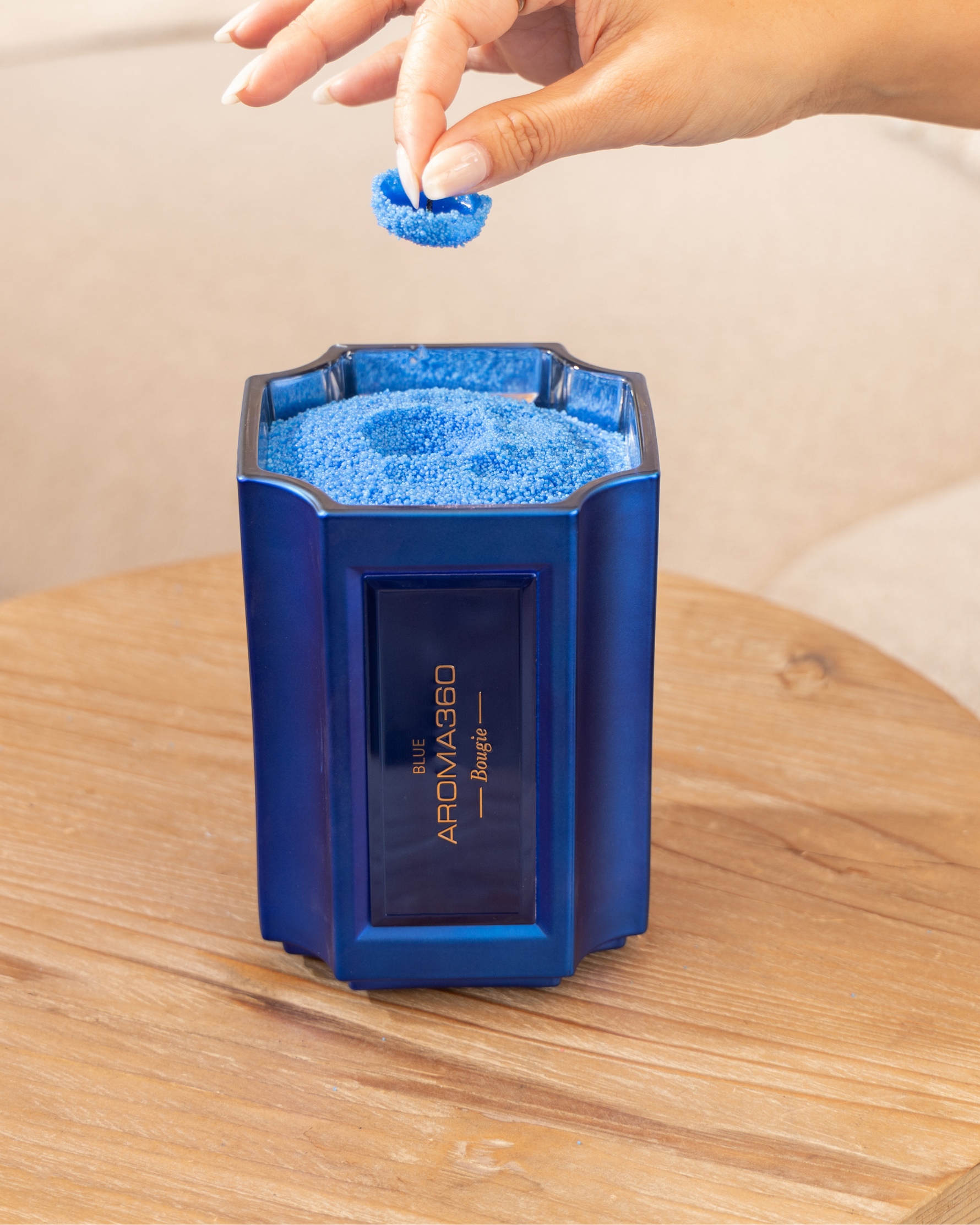 The Bougie Sand Wax Set features a 40oz scented sand wax, 30 candle wicks, and a stunning 33oz recyclable metallic vessel. Available in Blue, Red, Black, Green, and Purple scents, this eco-friendly, refillable candle set offers a sustainable and opulent ambiance.